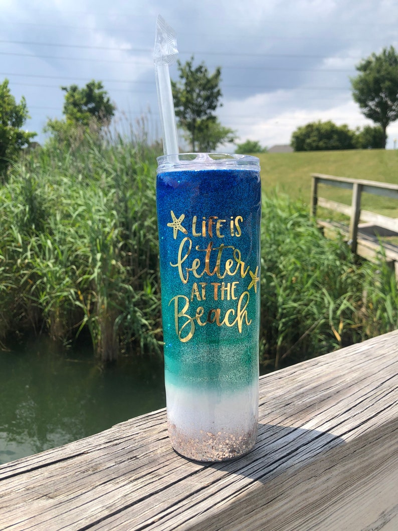 The glitter tumbler is designed with a beach-themed pattern and a quote "Life is better at the beach". Made of stainless steel, it'll last for good.