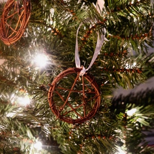 woven grapevine with ribbon tied on it to create a pentacle ornament