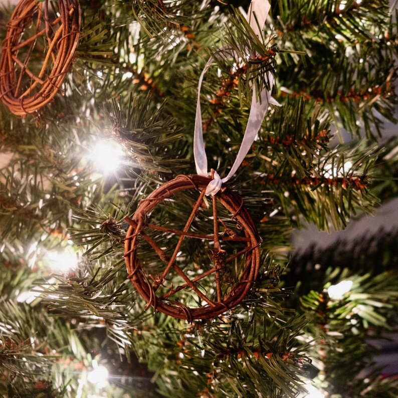 woven grapevine with ribbon tied on it to create a pentacle ornament