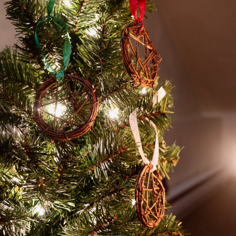 woven grapevine with ribbon tied on it to create a pentacle ornament