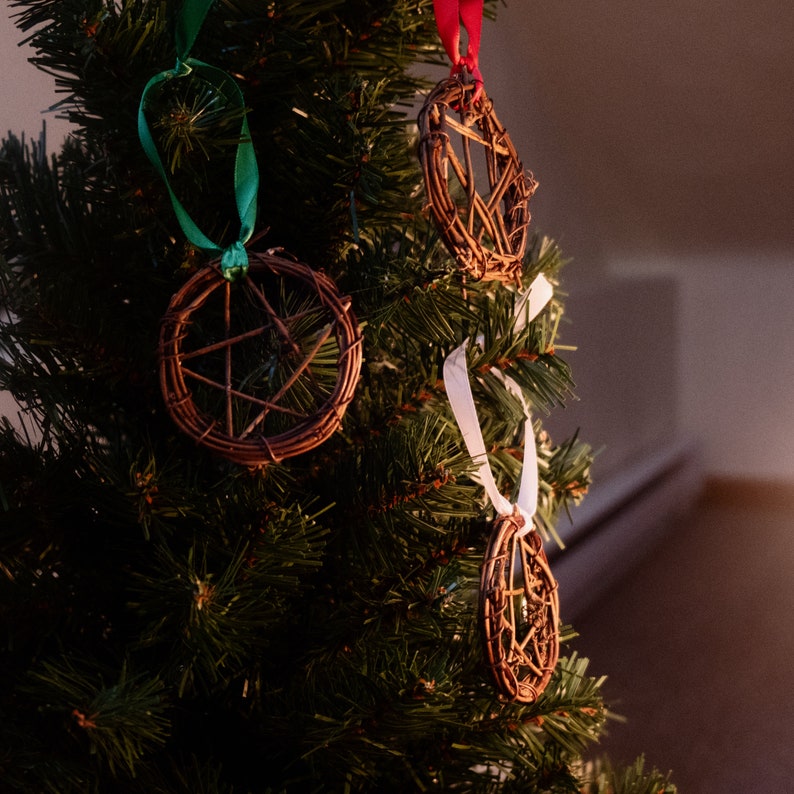 woven grapevine with ribbon tied on it to create a pentacle ornament