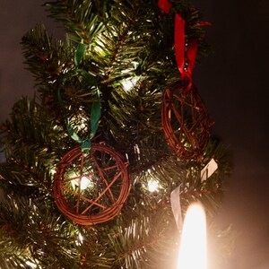 woven grapevine with ribbon tied on it to create a pentacle ornament