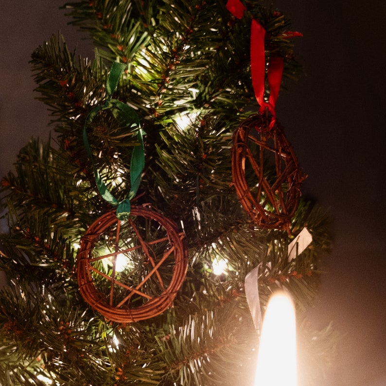 woven grapevine with ribbon tied on it to create a pentacle ornament