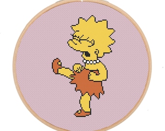May include: A cross-stitch embroidery hoop with a pink background and a yellow cartoon character with yellow hair, wearing a brown skirt and a pearl necklace. The character is kicking their leg up in the air.