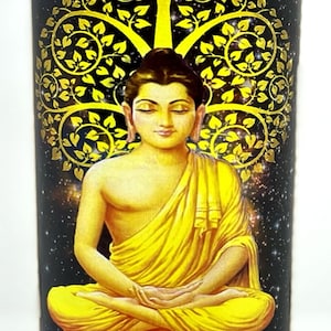 May include: A tall glass candle with a label featuring a golden Buddha image seated in meditation under a golden tree. The words "Buddha" and "Enlightenment" are printed on the label.