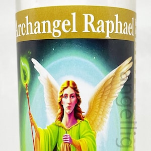 May include: A candle with a picture of Archangel Raphael on the front. The archangel is depicted with wings and a staff. The candle is white with gold lettering that says "Archangel Raphael".