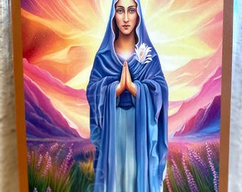 May include: An artistic depiction of Mother Mary, with the text "Mother Mary" at the top and "Divine Mother" at the bottom. She is wearing a blue veil and robe, with hands clasped in prayer. The background features a colorful sunset and lavender field.