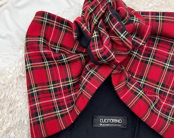 May include: A red plaid turban with black and white accents. The turban features a knotted design and a black interior. The label reads "CUCITORINO - Be yourself/Love yourself -."