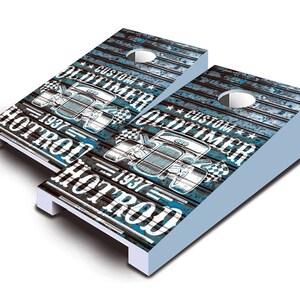 May include: Two blue and white wooden cornhole boards with a vintage car graphic and the text "Custom Oltimer 1937 Hotrod" on each board.