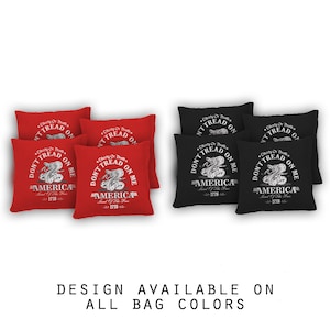 May include: Six bean bags with a red and black color scheme. The bean bags feature a white graphic of a snake with the text "Don't Tread On Me" and "America Land of the Free 1776".