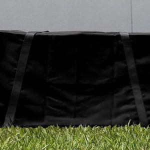 May include: Black canvas carrying case with two adjustable straps. The case is closed and sitting on green grass.