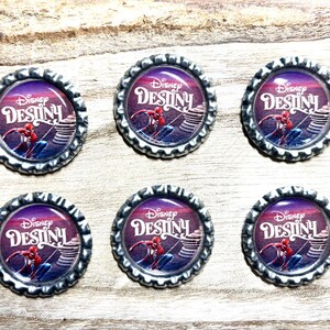 May include: Six circular metal bottle caps featuring a glossy graphic insert. Each cap displays the Disney Destiny logo in white text above an illustration of the character Spider-Man in a red and blue suit, set against a purple gradient background.