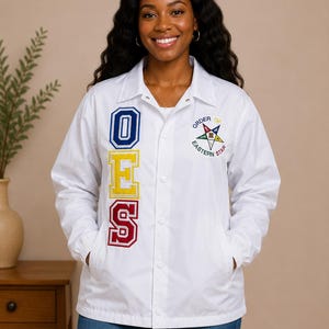 May include: A white snap-front coach jacket featuring the vertical embroidered letters OES in blue, yellow, and red on the right side and the Order of the Eastern Star emblem with a five-pointed star and text on the left chest area.