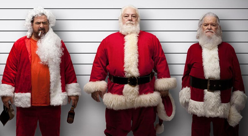 May include: Three men dressed as Santa Claus stand in a police lineup. The man on the left is holding a beer bottle and a cigarette. The man in the middle is standing with his hands on his hips. The man on the right is standing with his hands in his pockets.