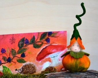Flower child pumpkin handmade out of wool felt and wool. Waldorf inspired for on the nature table.