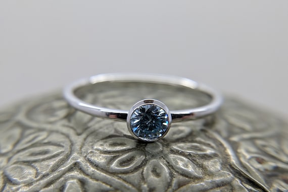 Blue Moissanite Round Brilliant Bezel Solitaire Ring