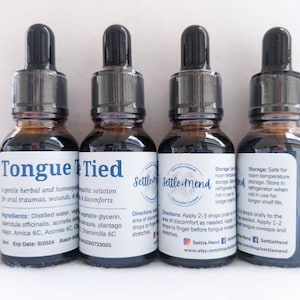May include: Four small brown glass bottles with black droppers. Each bottle has a white label with text. The labels read "Tongue Tied" and "Settle-Mend". The bottles contain a herbal solution for oral traumas and discomforts.