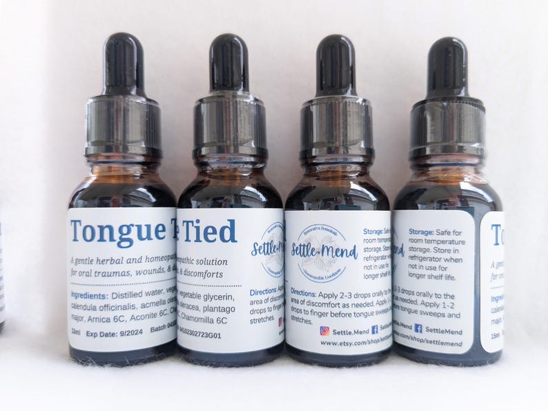 May include: Four small brown glass bottles with black droppers. Each bottle has a white label with text. The labels read "Tongue Tied" and "Settle-Mend". The bottles contain a herbal solution for oral traumas and discomforts.