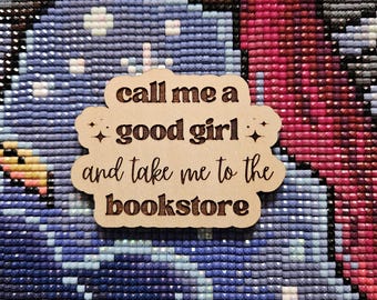 May include: Wooden sign with the text "Call me a good girl and take me to the bookstore" in a cloud shape with a sparkly design.