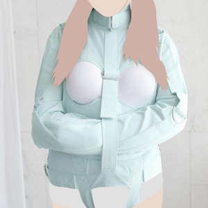 May include: A light blue restraint jacket with straps and buckles. The jacket has long sleeves and a high collar. The model is wearing a white undergarment.