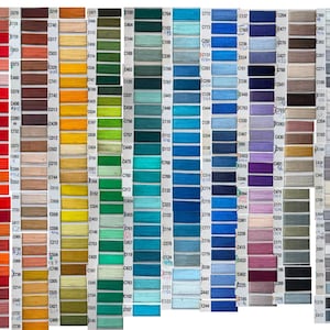 May include: A comprehensive color chart featuring numerous small, rectangular swatches of embroidery thread arranged in vertical columns. Each swatch is labeled with a unique alphanumeric code, displaying a full spectrum of colors including reds, yellows, greens, blues, purples, browns, grays, and blacks.