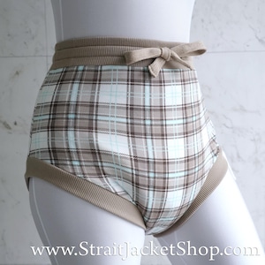 May include: High-waisted underwear with a plaid pattern in shades of brown, white, and light blue. The waistband and leg openings are trimmed with a solid tan fabric. A small bow detail is centered on the front of the waistband.
