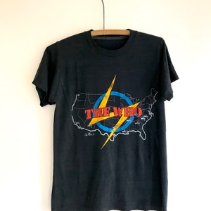 May include: Black t-shirt with a graphic of a lightning bolt and the words "The Who" over a map of the United States.