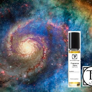 May include: A small glass bottle of perfume with a black cap and a white label. The label says "The Perfume Project" and "Fragrance Name" with a space for the name. The bottle is in front of a colourful image of a galaxy.
