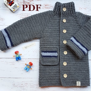 May include: Gray crocheted cardigan with blue and white stripes on the sleeves and pockets. The cardigan has a high collar and buttons down the front. The text "PDF" is visible in the image.