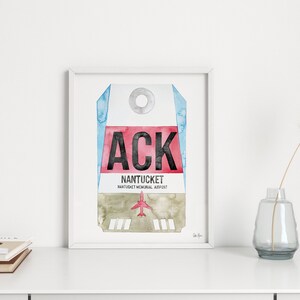 May include: A watercolor painting of a luggage tag with the airport code "ACK" and the text "NANTUCKET NANTUCKET MEMORIAL AIRPORT".