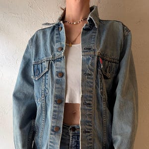 May include: A set of three ceramic mugs with a speckled, matte finish. The mugs are in shades of cream, light gray, and dark gray. Each mug has a simple, minimalist design and a rounded handle.