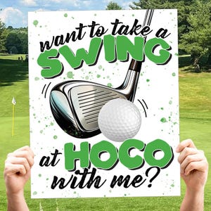 May include: A rectangular sign featuring a golf club and a white golf ball. The text reads "want to take a SWING at HOCO with me?" in black and green lettering. The background is white with green paint splatters and a golf course scene.