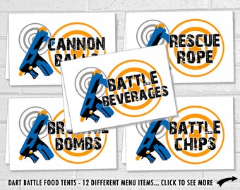 May include: Twelve printable food tent signs for a dart battle party. Each sign features a blue and orange target with a toy gun and text. The signs include: Cannon Balls, Battle Beverages, Rescue Rope, Battle Chips, and  BR Bombs.