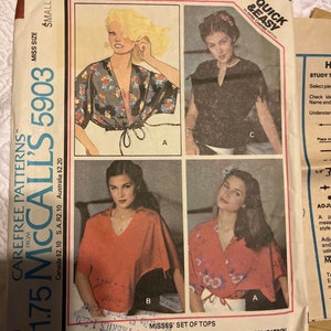 May include: A sewing pattern for a set of tops. The pattern includes instructions for three different styles of tops, all with a wrap-style design. The pattern is for misses' sizes and is from McCall's.