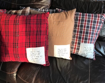 May include: Four plaid pillow covers with a white fabric patch sewn on each. The patches have handwritten text that reads "This is a shirt I used to wear Whenever you hold it know that I am there Love, Pop".