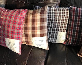 May include: Four plaid pillow covers with handwritten messages sewn on. The messages are about love and memories. The pillows are on a brown leather couch.