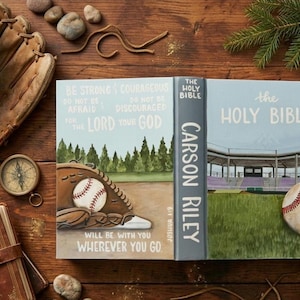 May include: A hardcover Holy Bible with a custom dust jacket featuring a baseball theme. The front cover displays a baseball glove, a baseball, a stadium, and the text: Be strong and courageous, do not be afraid, do not be discouraged, for the Lord your God will be with you wherever you go, Joshua 1:9.
