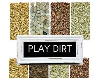 May include: Sensory bin filled with different textures, including craft paper, rocks, rice, and shredded paper. The bin is labeled "Sensory Bin Large" and "Play Dirt".