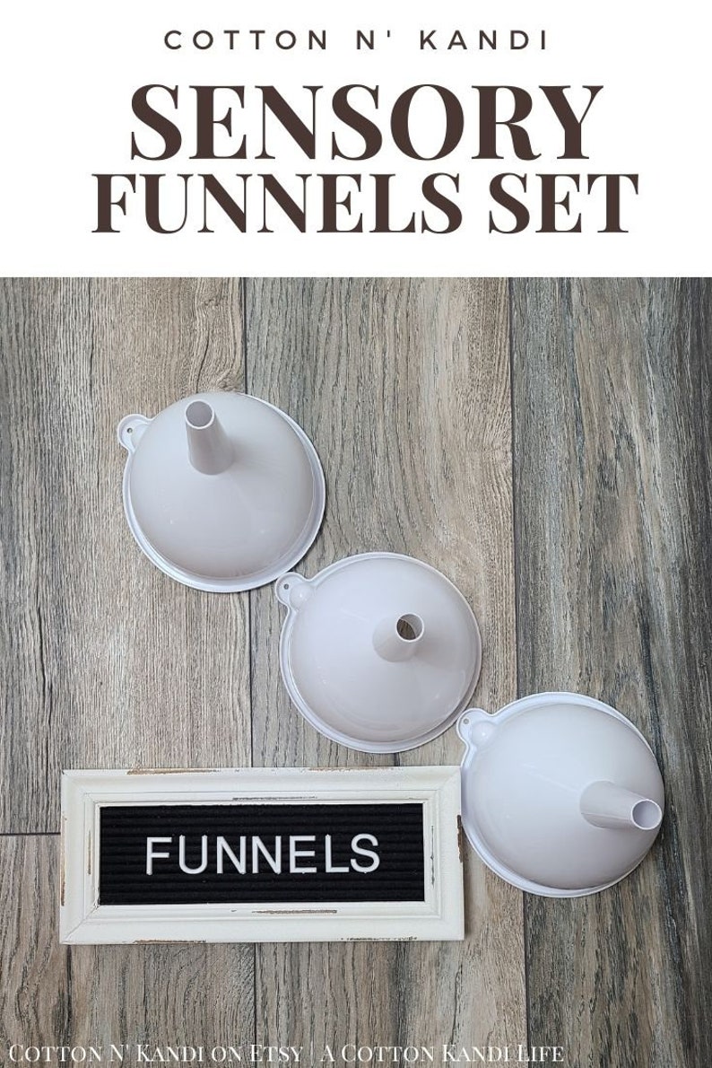 May include: Set of three white plastic funnels, labelled "FUNNELS" on a black letter board. Sensory funnels for children.