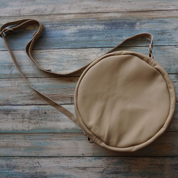 round tan bag