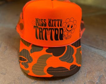 Miss Kitty neon orange camo trucker hat