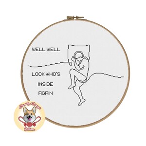 May include: A black and white cross-stitch pattern featuring a person sleeping in bed with the text "Well well, look who's inside again".