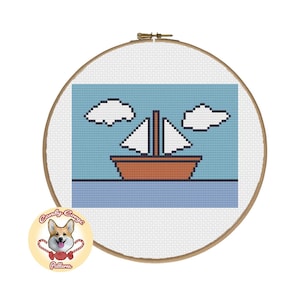 Może przedstawiać: Wzór na haft krzyżykowy przedstawiający żaglówkę z białymi żaglami i brązowym kadłubem, płynącą po błękitnym morzu z białymi chmurami na niebie.