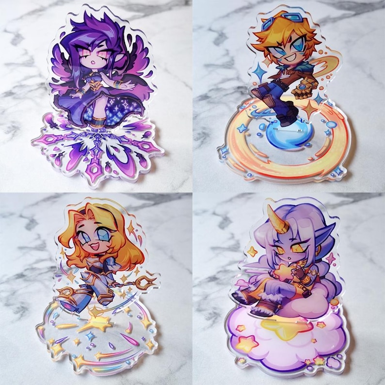 May include: Four acrylic character charms with vibrant anime-style illustrations. Each charm showcases a different character with distinct designs and poses. The charms are on clear bases with decorative elements.