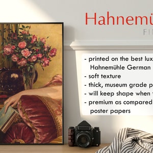 May include: A framed painting of a woman's hand resting on a red velvet cushion. A bouquet of pink roses in a vase is in the background. The painting is printed on Hahnem&uuml;hle German Etching paper, a high-quality paper known for its soft texture and archival quality.