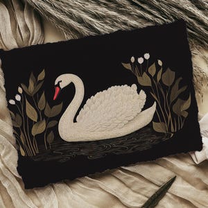 May include: A white swan with a red beak swims in a dark blue pond with gold leaf details. The swan is surrounded by gold leaf plants with white flowers.