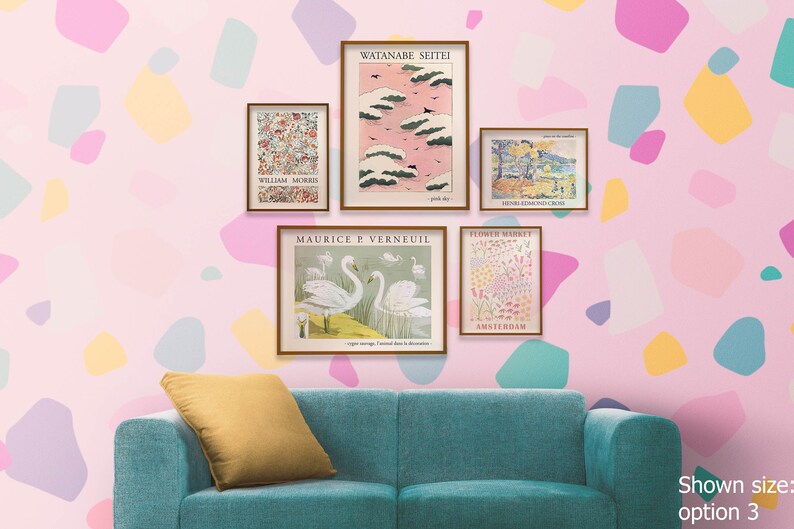 May include: Five framed art prints with various designs, including a pink sky with clouds, a flower market, swans, and a floral pattern. The prints are hanging on a pink wall with a teal couch in the foreground.