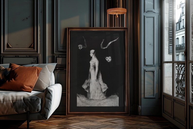 May include: A black and white framed print of a woman in a long dress standing in front of a dark background. There are three abstract shapes above her head.