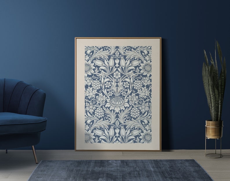 May include: A framed print of a blue and white floral pattern. The pattern features a repeating design of stylized flowers, leaves, and vines. The print is framed in a simple, light wood frame.