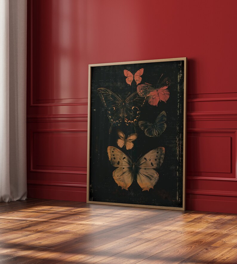May include: A framed print of a black background with a collection of butterflies in various shades of brown, orange, and pink. The butterflies are arranged in a cluster, with some overlapping.